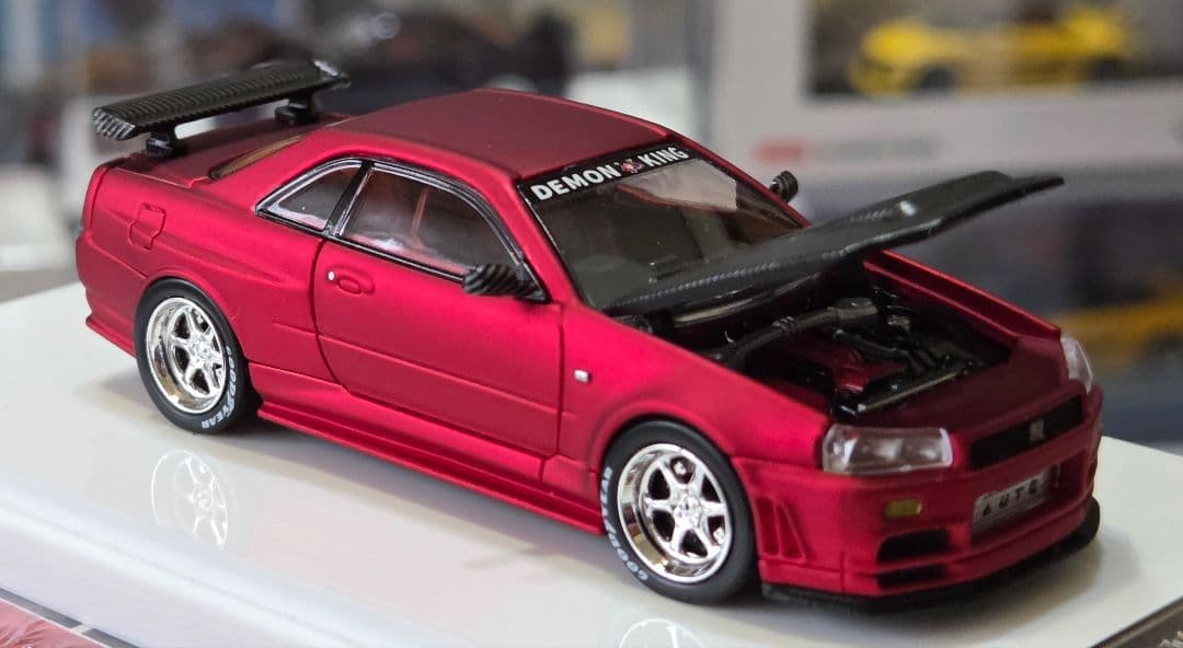 限定700台1/64車魔王AUTOEXPO2025日産スカイラインGT-R34赤