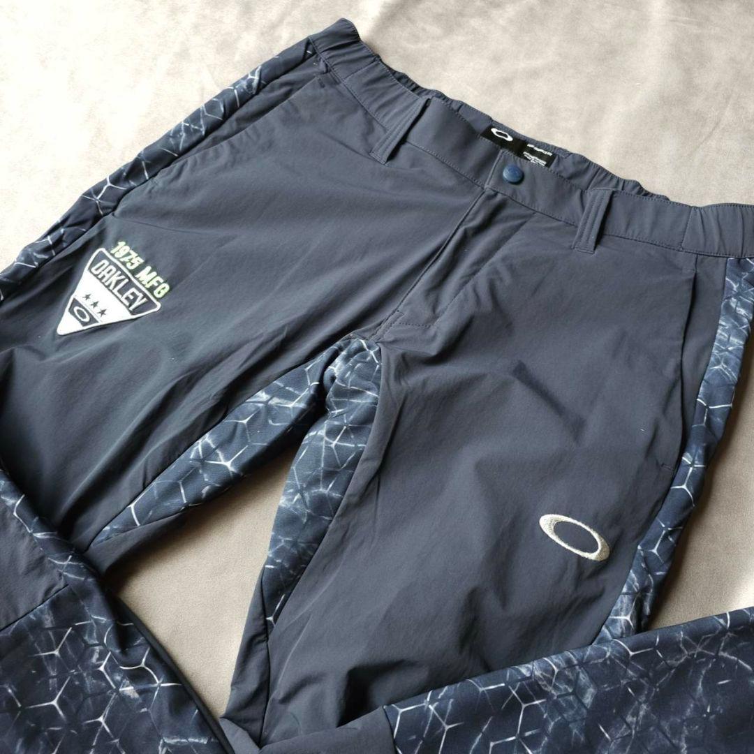 【オークリーゴルフ】蓄熱HEAT×防風 グラフィックデザイン 秋冬ゴルフバンツM